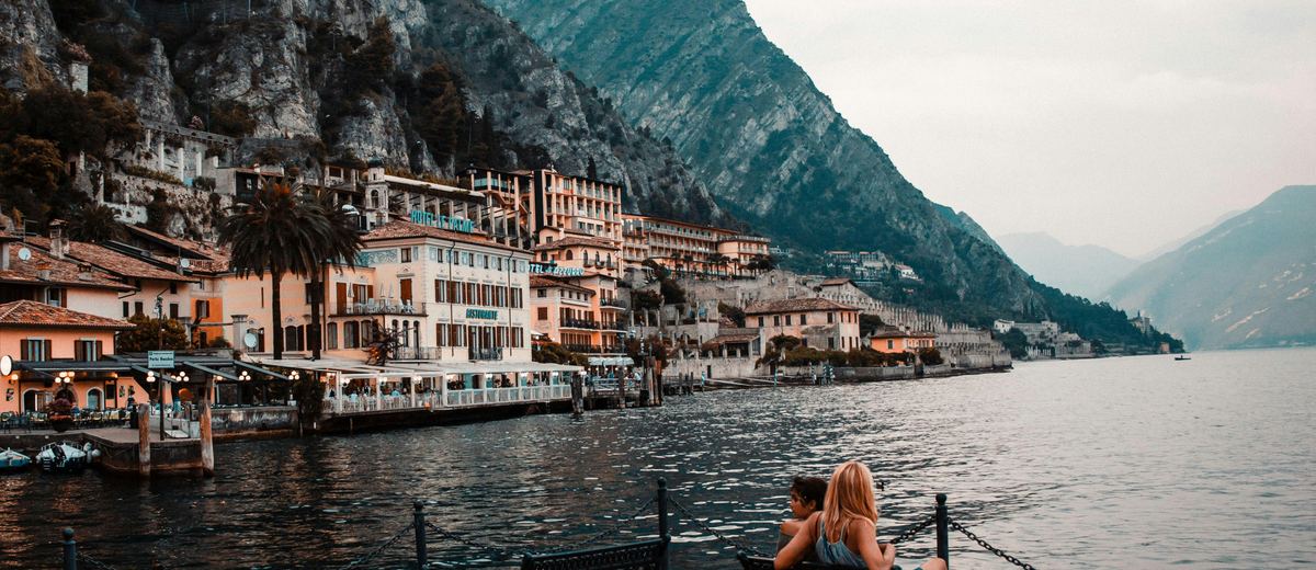 A lake and mountains at golden hour, the kind of destination a trip wardrobe is planned around.